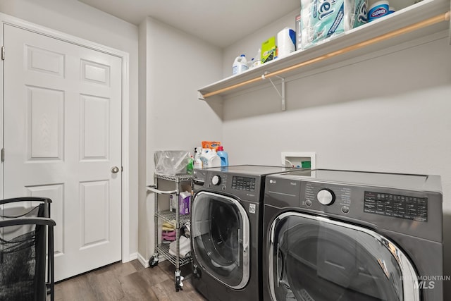 laundry area featuring dark hardwood / wood-style flooring and washing machine and dryer