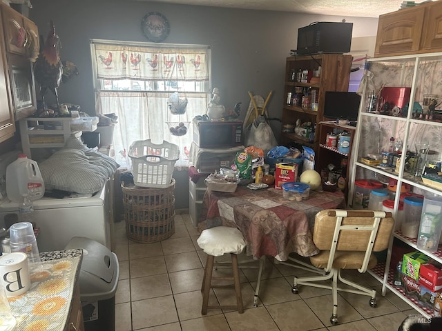 dining room with light tile patterned floors and washer / dryer