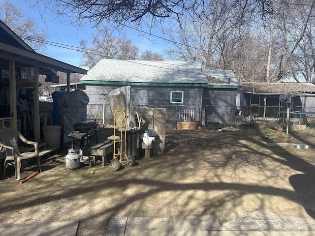 rear view of house featuring fence