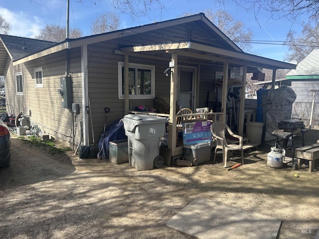 back of property featuring a shingled roof