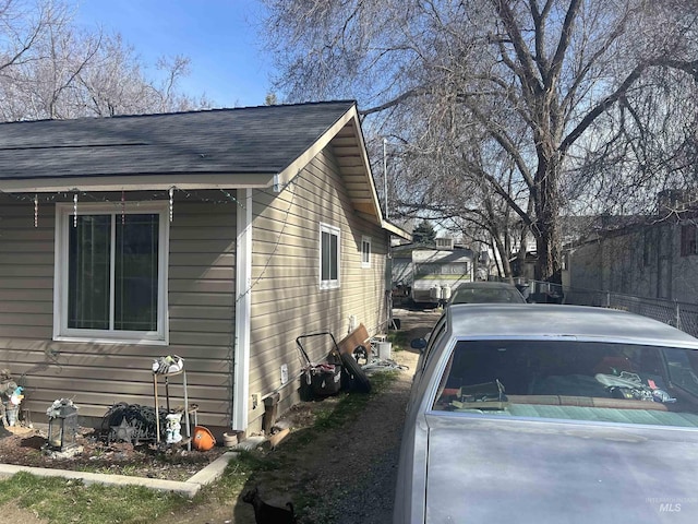 view of side of property with a shingled roof