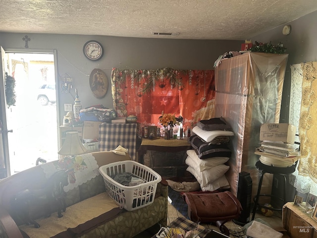 misc room with visible vents and a textured ceiling