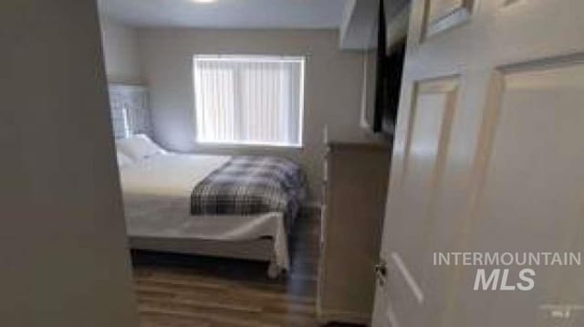 bedroom with wood-type flooring