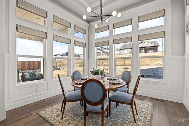 sunroom / solarium with a healthy amount of sunlight and an inviting chandelier