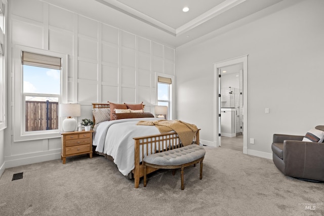 bedroom featuring ensuite bathroom, a high ceiling, and carpet floors