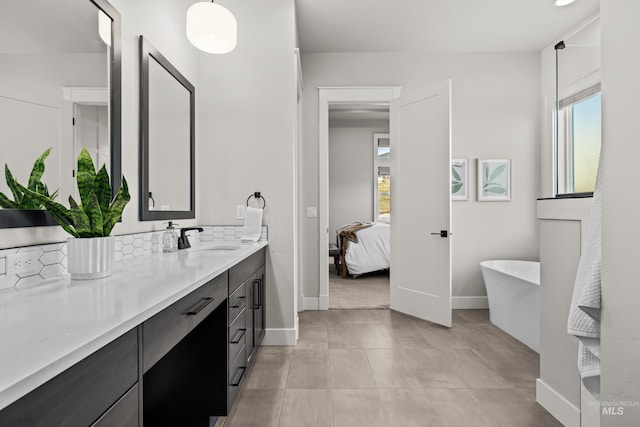 bathroom with a tub to relax in and vanity