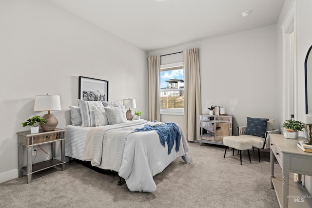 bedroom featuring light colored carpet