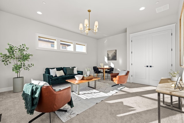 living room with an inviting chandelier and light carpet