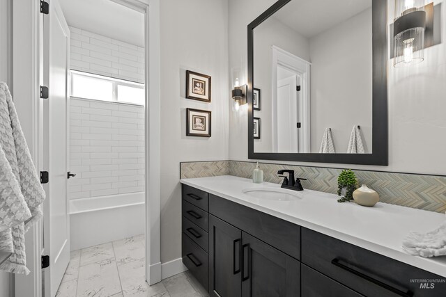 bathroom with vanity and tiled shower / bath