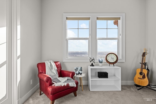 living area featuring light carpet