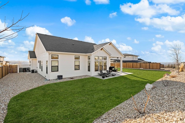 rear view of house with a patio area and a lawn