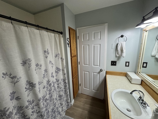full bathroom featuring curtained shower, wood finished floors, and vanity
