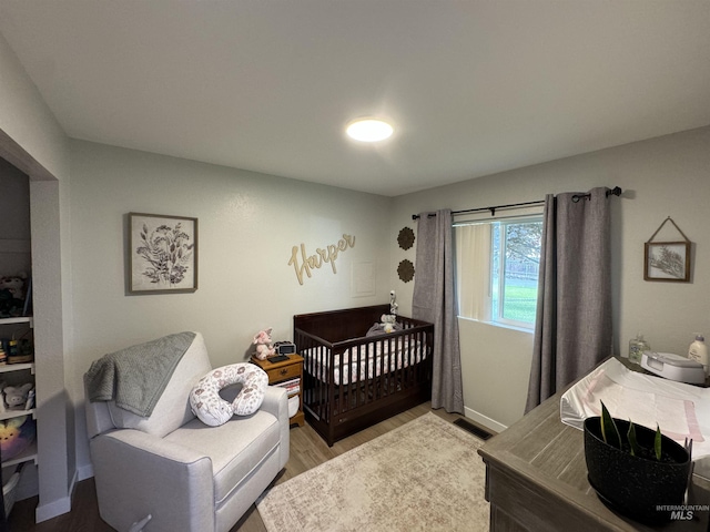bedroom with light wood-style floors and visible vents