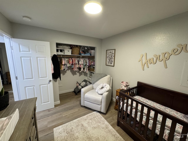 bedroom with baseboards, a closet, and wood finished floors
