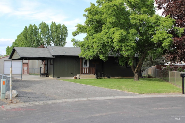 ranch-style house with an outdoor structure, a front lawn, fence, driveway, and a detached garage