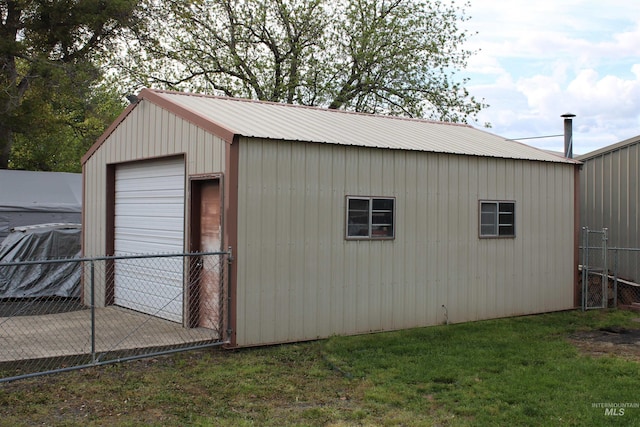view of outbuilding with fence and an outdoor structure