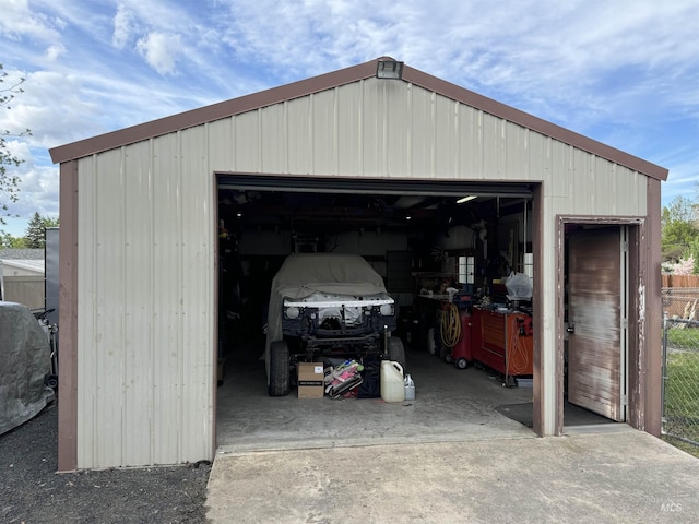 detached garage featuring fence