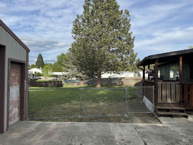 view of yard featuring fence and a gate