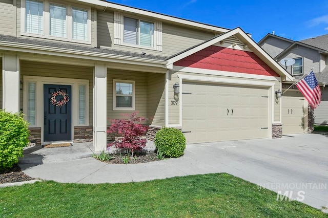 view of front of house featuring covered porch and a garage