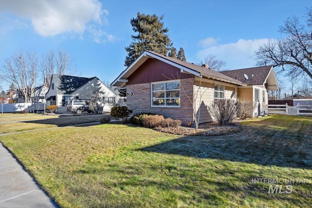 view of side of home featuring a lawn