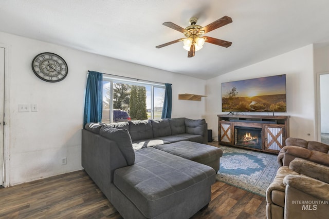 living room featuring vaulted ceiling, dark wood-type flooring, and ceiling fan