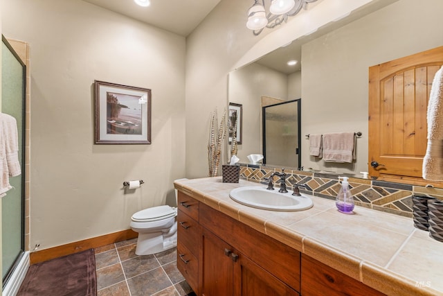 1305 Greystone, Mccall, ID 83638 - bathroom featuring baseboards, a shower stall, vanity, and toilet