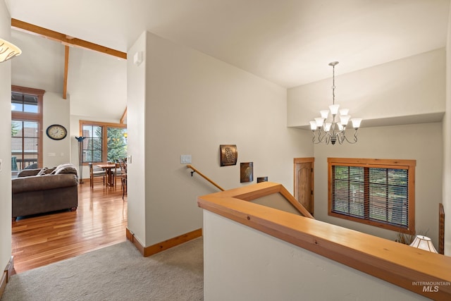 1305 Greystone, Mccall, ID 83638 - corridor with an upstairs landing, high vaulted ceiling, baseboards, carpet, and a chandelier