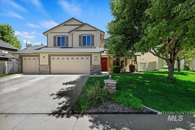 view of front of home featuring concrete driveway, a front lawn, and fence