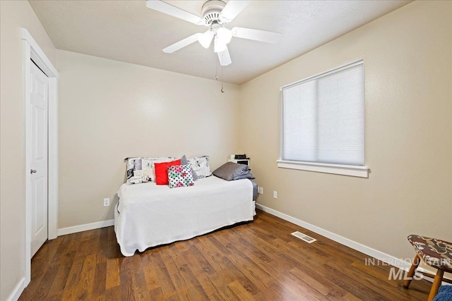 bedroom featuring wood finished floors, visible vents, and baseboards