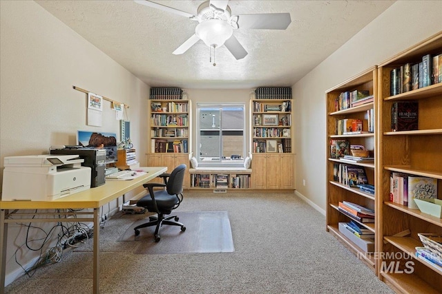 office with baseboards, carpet, a ceiling fan, and a textured ceiling