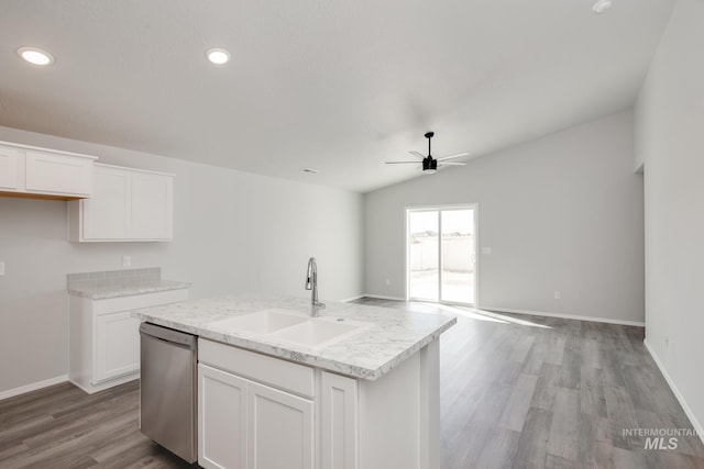 kitchen featuring dishwasher, a center island with sink, sink, vaulted ceiling, and white cabinetry