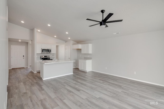 unfurnished living room with sink, high vaulted ceiling, light hardwood / wood-style floors, and ceiling fan