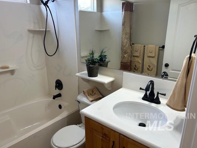 bathroom featuring vanity, toilet, and shower / bath combo with shower curtain