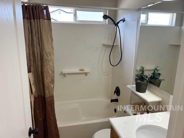 full bath featuring toilet, shower / bath combo, and vanity