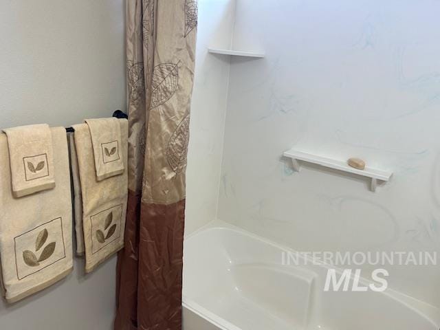 bathroom featuring a bathing tub and a shower with curtain