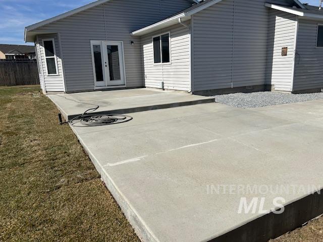 rear view of house with a patio area, a yard, and fence