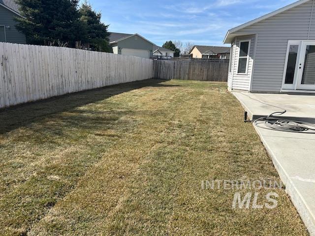 view of yard with a patio area and a fenced backyard