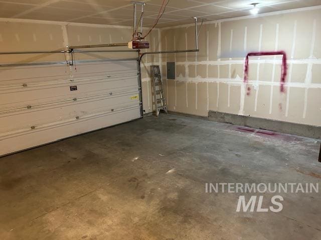 garage with electric panel and a garage door opener