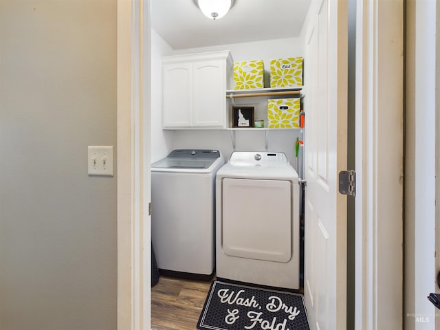 laundry area featuring cabinets, separate washer and dryer, and hardwood / wood-style flooring