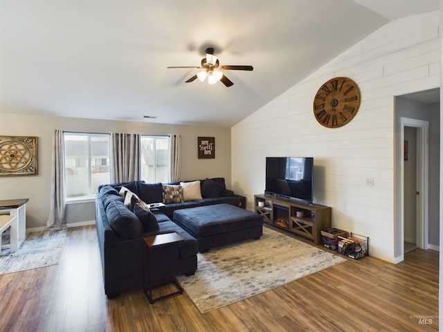 living room featuring lofted ceiling, ceiling fan, and dark hardwood / wood-style floors