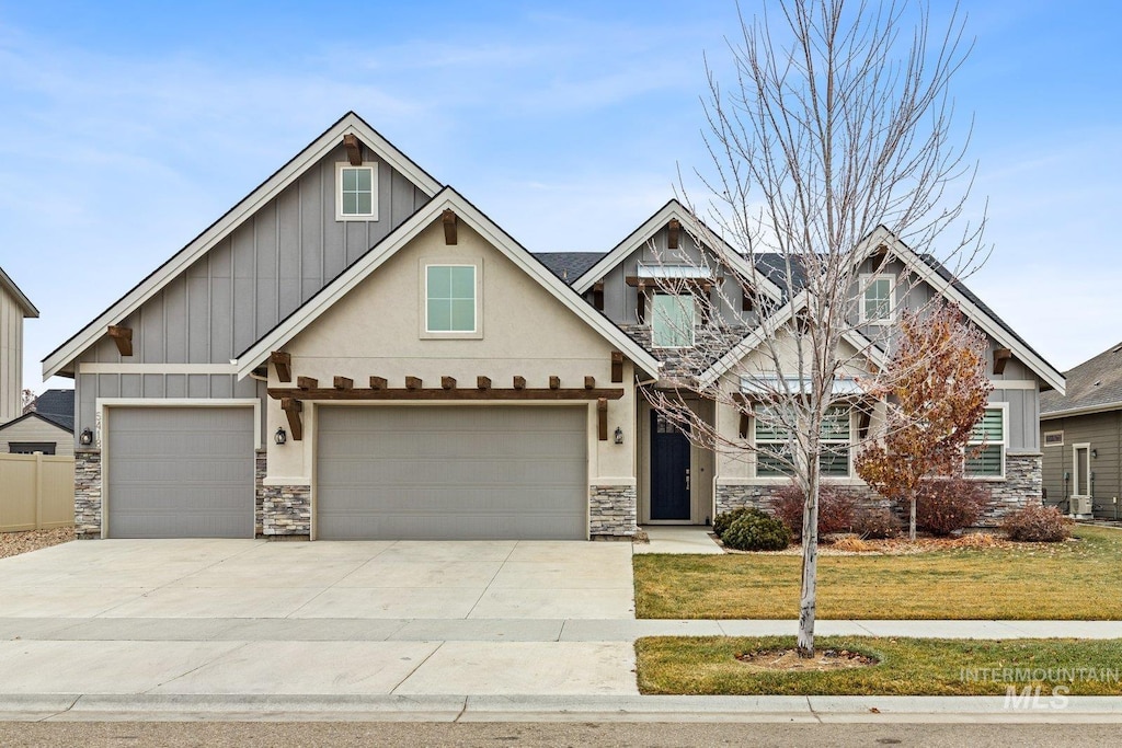 craftsman-style home with a garage and a front lawn