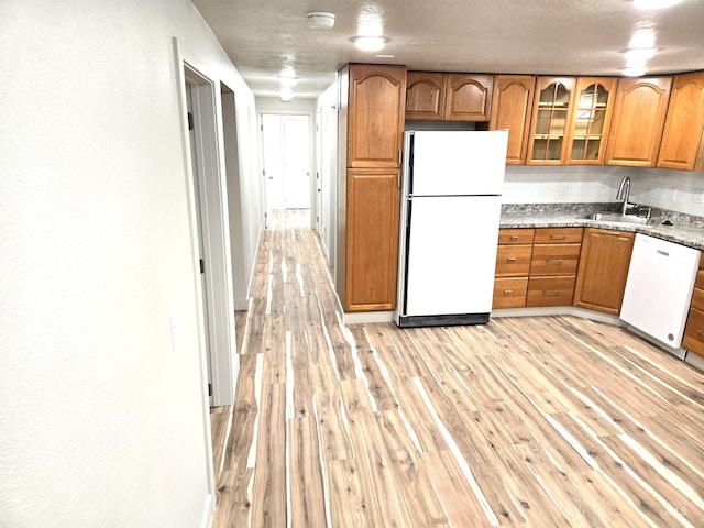 3004/3006 W Gerrard St, Boise, ID 83703 - kitchen with white appliances, light wood-style flooring, brown cabinets, and glass insert cabinets