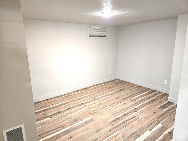3004/3006 W Gerrard St, Boise, ID 83703 - spare room featuring light wood-type flooring and a textured ceiling