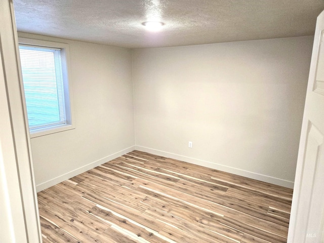 3004/3006 W Gerrard St, Boise, ID 83703 - empty room with a textured ceiling and light wood-style floors