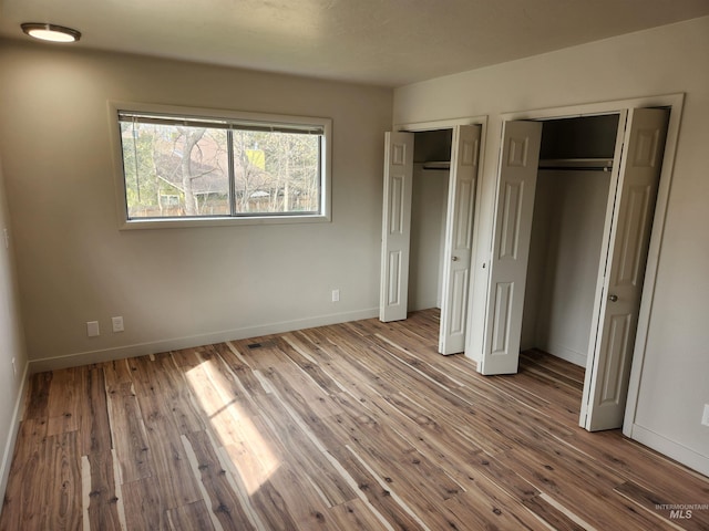 3004/3006 W Gerrard St, Boise, ID 83703 - unfurnished bedroom with two closets and wood finished floors