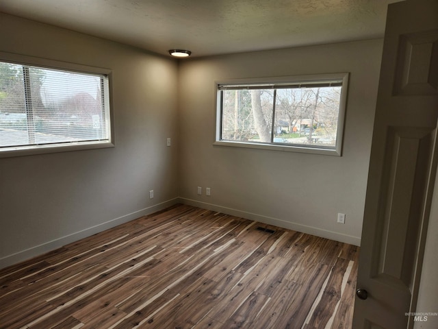 3004/3006 W Gerrard St, Boise, ID 83703 - unfurnished room with dark wood-style floors and baseboards