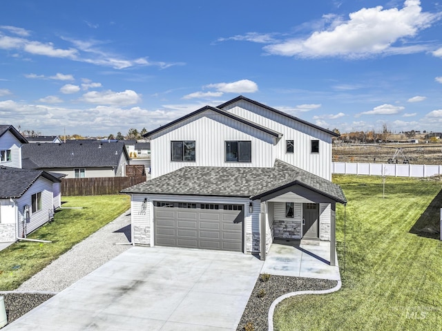 modern farmhouse with a shingled roof, a front lawn, fence, concrete driveway, and an attached garage