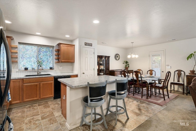 4590 E Stone Falls Dr, Nampa, ID 83686 - kitchen with a sink, black dishwasher, light countertops, plenty of natural light, and recessed lighting