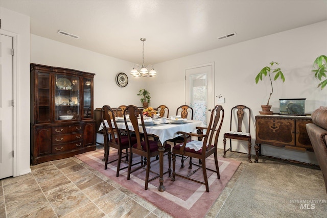 4590 E Stone Falls Dr, Nampa, ID 83686 - dining area featuring a chandelier and light stone finish floors