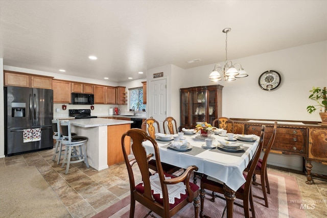 4590 E Stone Falls Dr, Nampa, ID 83686 - dining area with a chandelier, light stone finish flooring, and recessed lighting